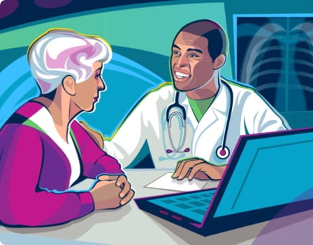 A doctor speaking with a patient at his desk.