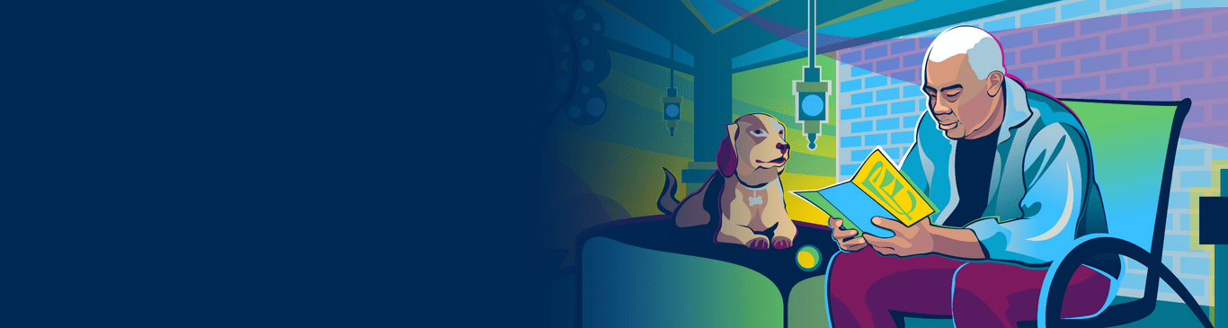 An older man sitting next to his dog and reading a pamphlet about idiopathic pulmonary fibrosis. 