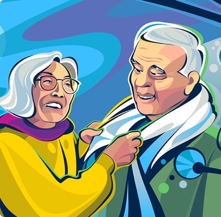 An older woman adjusting an older man’s scarf.