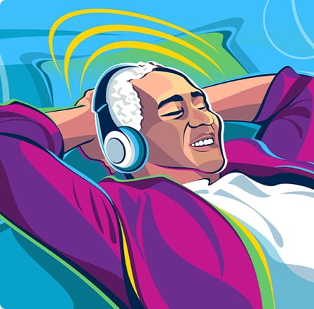 An older man wearing headphones leaning back in a chair listening to music.